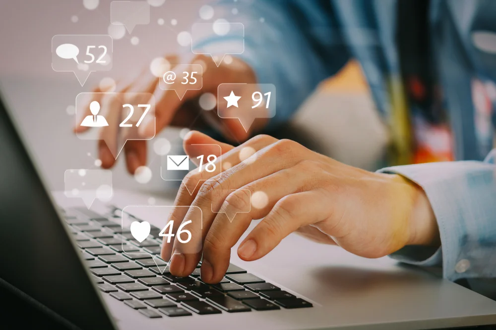 Businessman typing on laptop with social media and marketing icons overlay, representing branding’s impact on digital marketing performance.