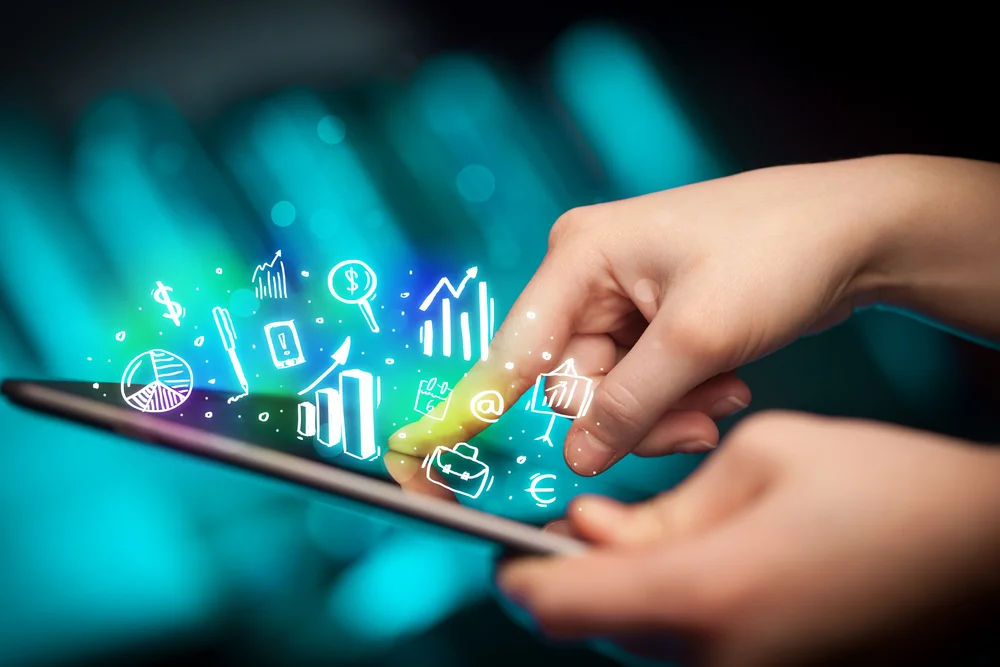 Hand pointing at digital tablet displaying marketing charts, symbolizing data-driven branding strategies in digital marketing.