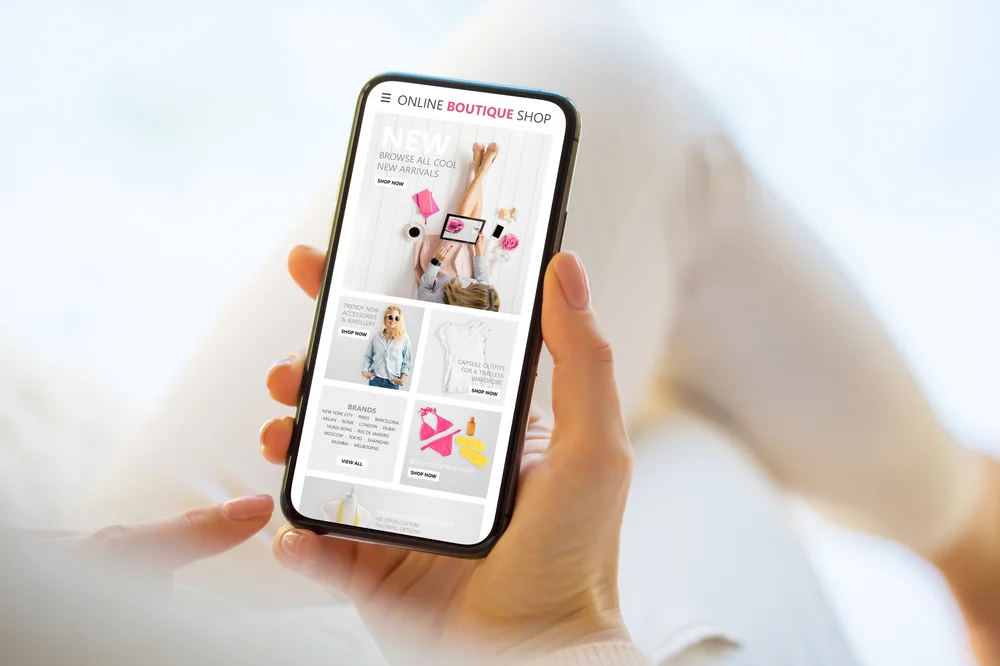 Woman shopping on mobile phone, representing app performance and user experience in cross-platform development.