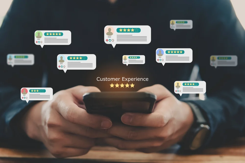Hand pressing smiley face with five-star rating icon on screen, symbolizing positive customer feedback and post-launch support in web development.