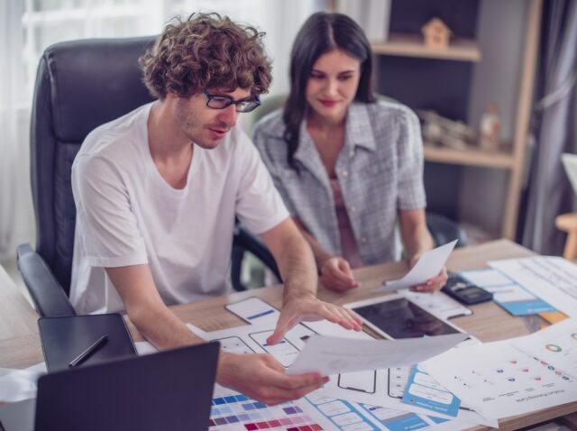 Mobile app developers collaborating on UI/UX design and prototyping for scalable, cross-platform business apps.