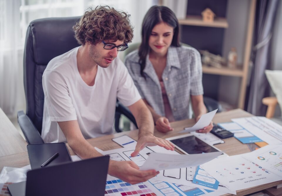 Mobile app developers collaborating on UI/UX design and prototyping for scalable, cross-platform business apps.